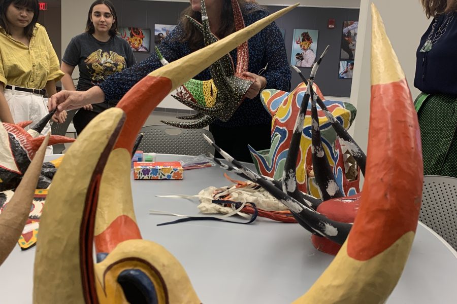 Dr. Michelle Wibbelsman with participants holding art sculptures