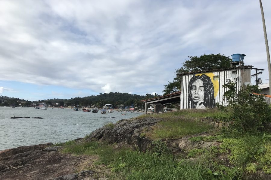 View of seashore with a painting on a house wall