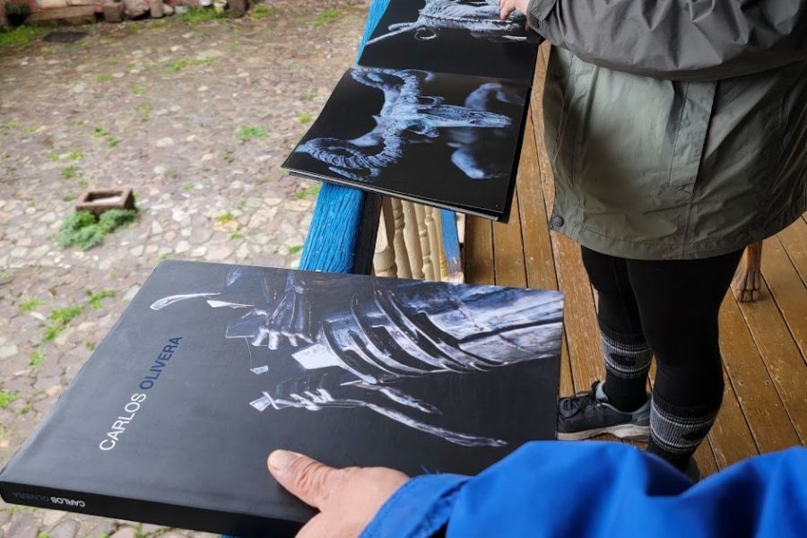 Participants examining Carlos Olivera art book